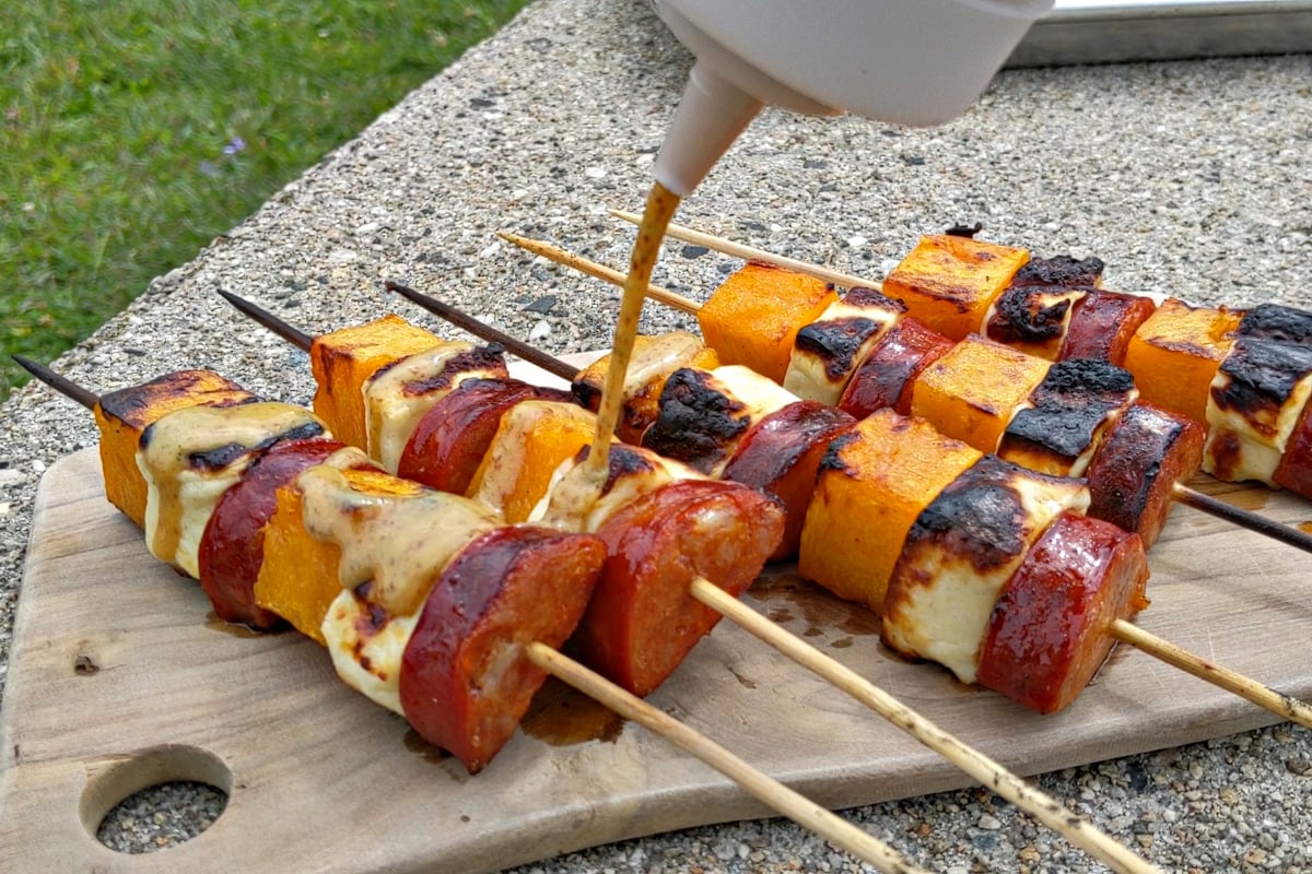 smothering the chorizo squash and cheese skewers with the sage honey mustard