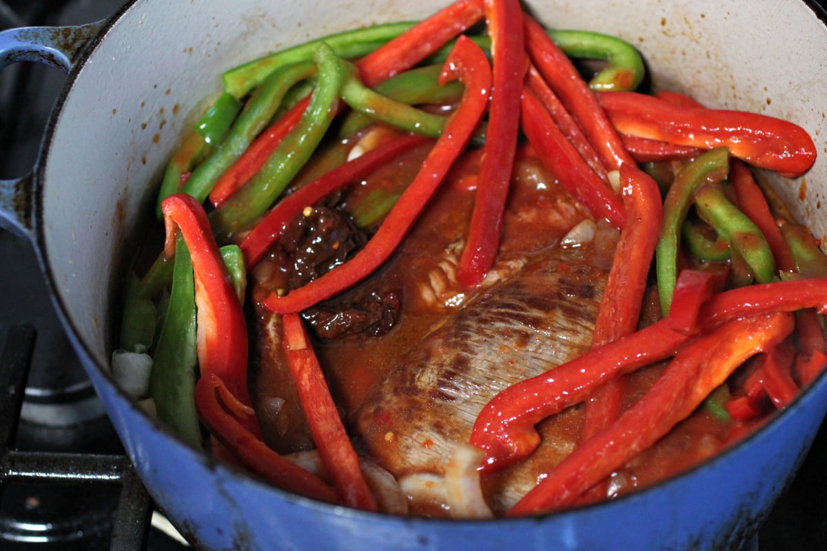 flank steak, peppers, and onions, in a pot
